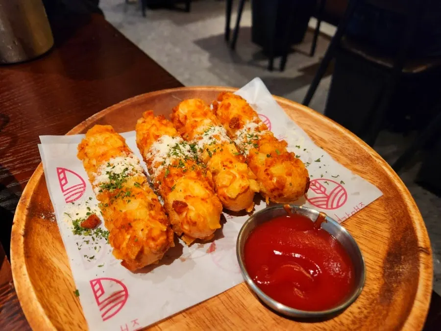 Plate of ordered potato cheese sticks