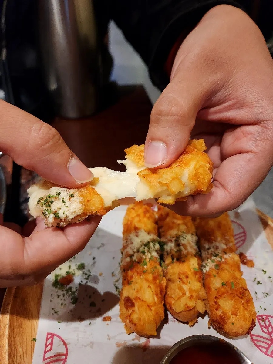 Potato cheese sticks with cheese stretching long
