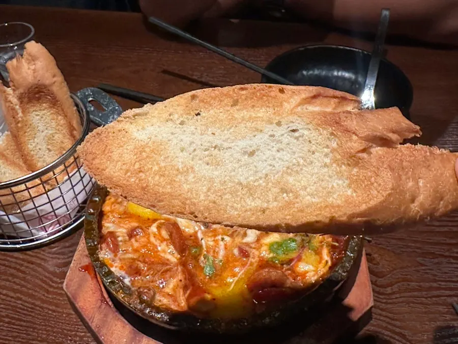 Crisp grilled baguette served alongside the egg-in-hell