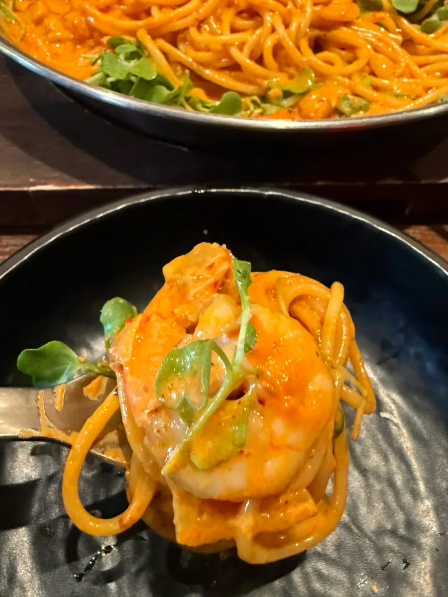 Cream pasta topped with plump shrimp