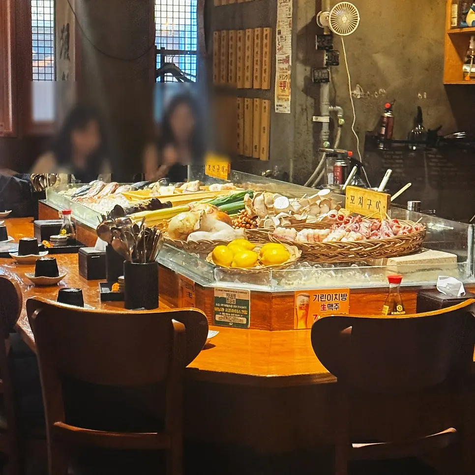 Bar counter and skewer-grilling area visible right at the entrance