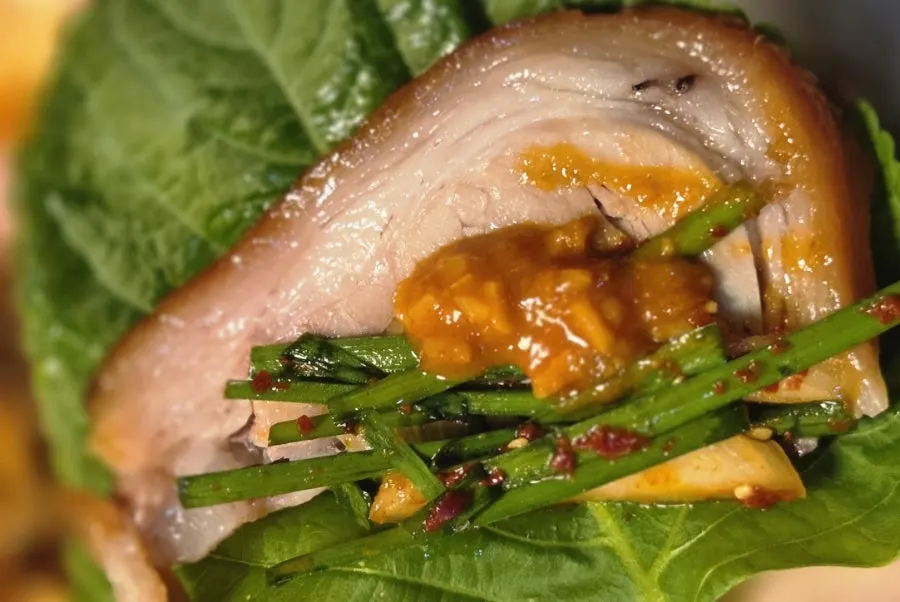 A piece of front leg jokbal topped with salted shrimp