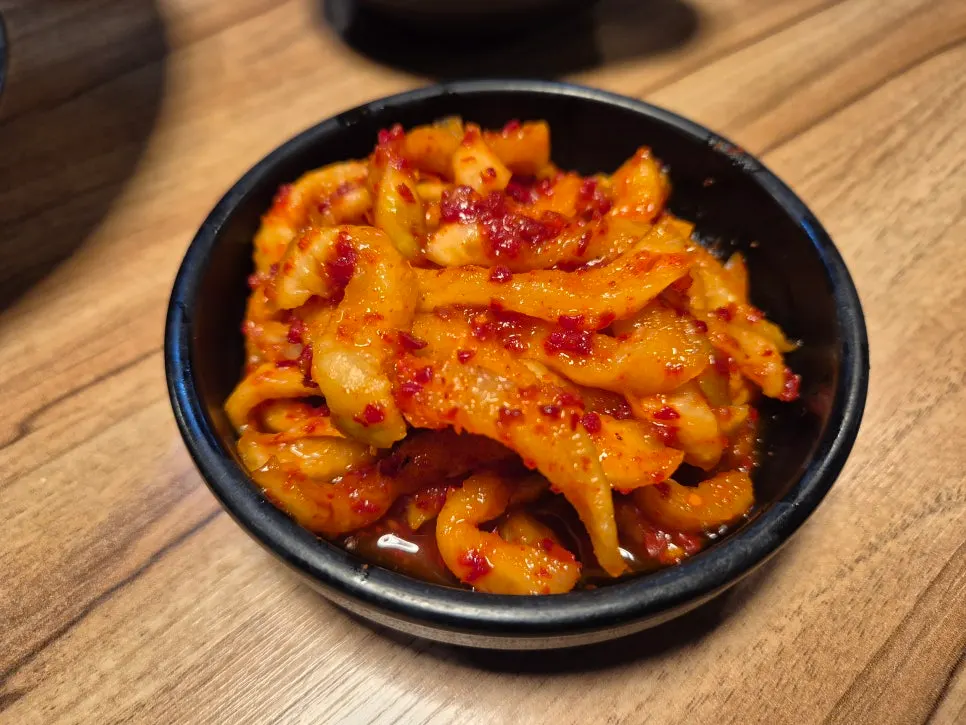 Spicy jokbal wrap eaten with rice balls