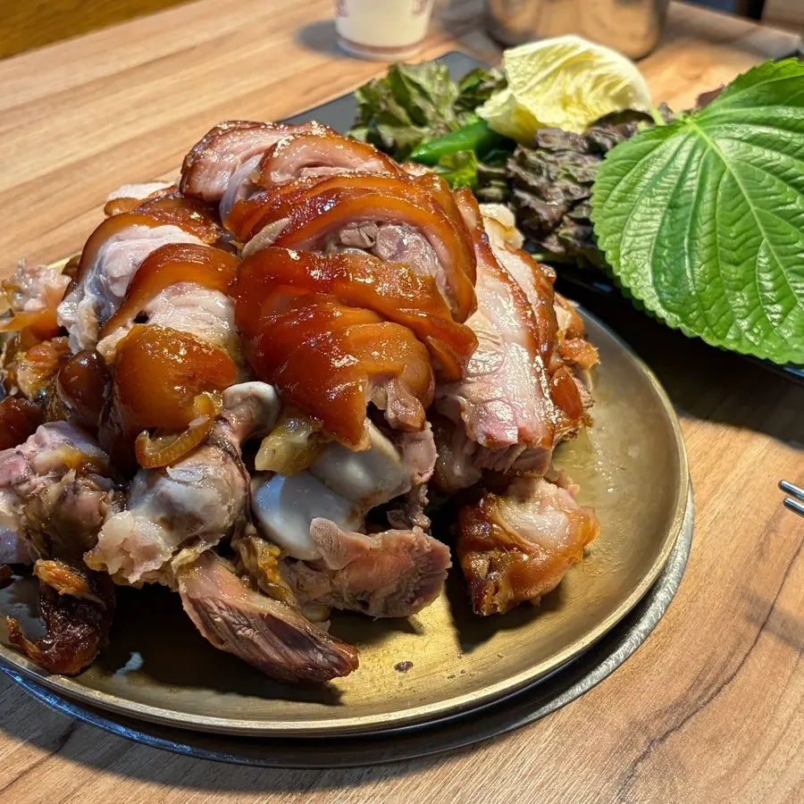 Jokbal piled high on a brass tray