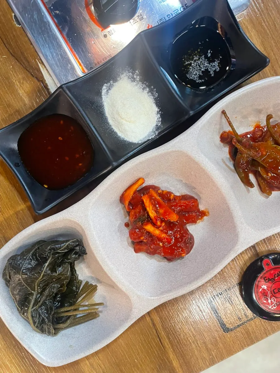 Dakgalbi dipped in self-serve bar sauces