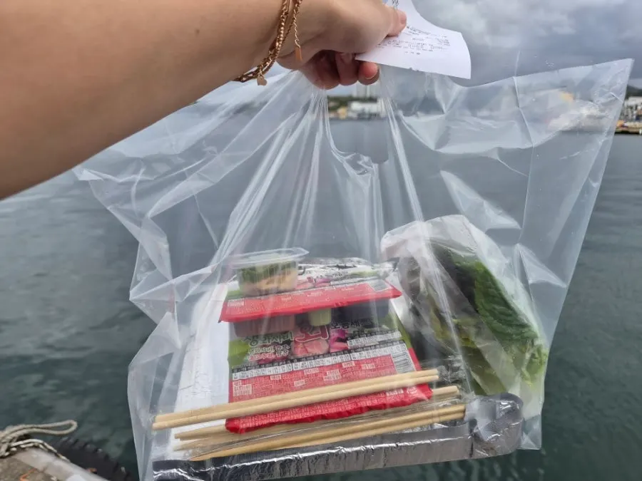 Mixed sashimi packed in a cooler bag with chojang sauce and vegetables
