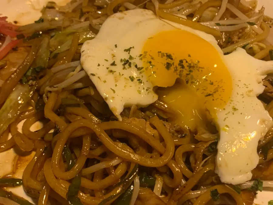 Close-up of yakisoba topped with egg yolk