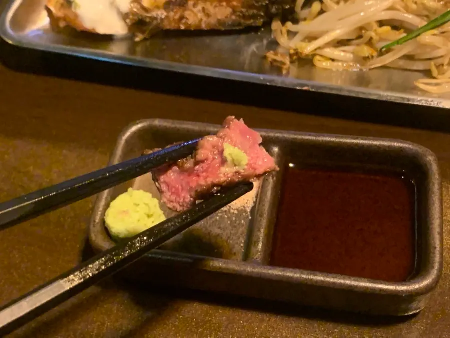 A piece of wagyu with salt and wasabi