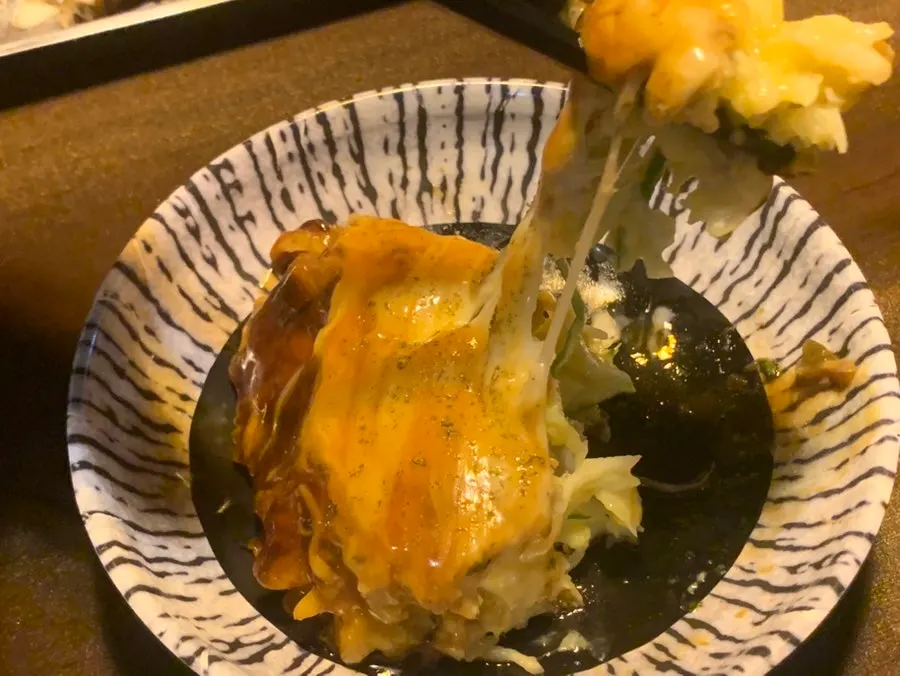 Cross-section of the okonomiyaki loaded with cabbage and seafood