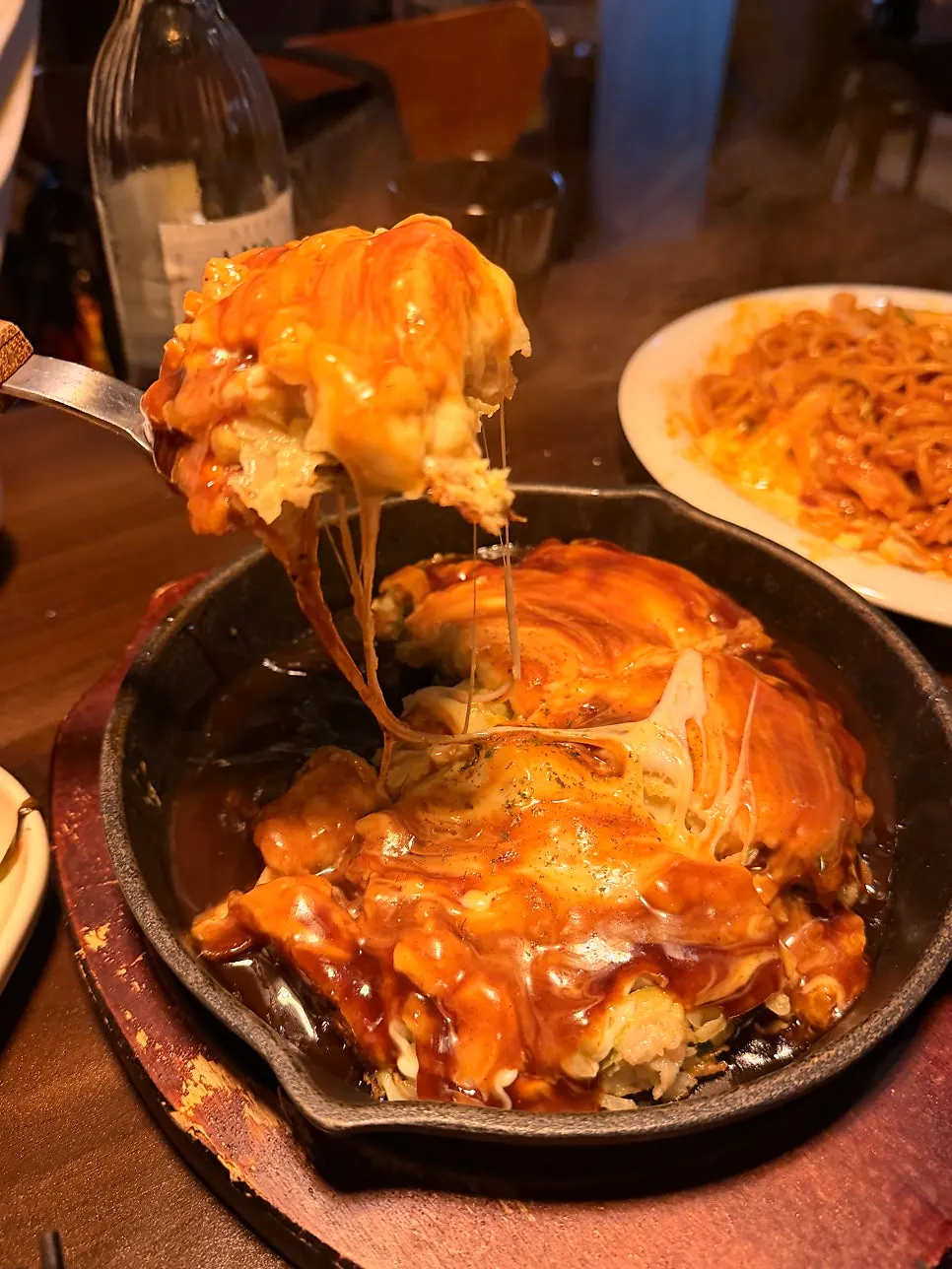 A slice of okonomiyaki lifted from the plate