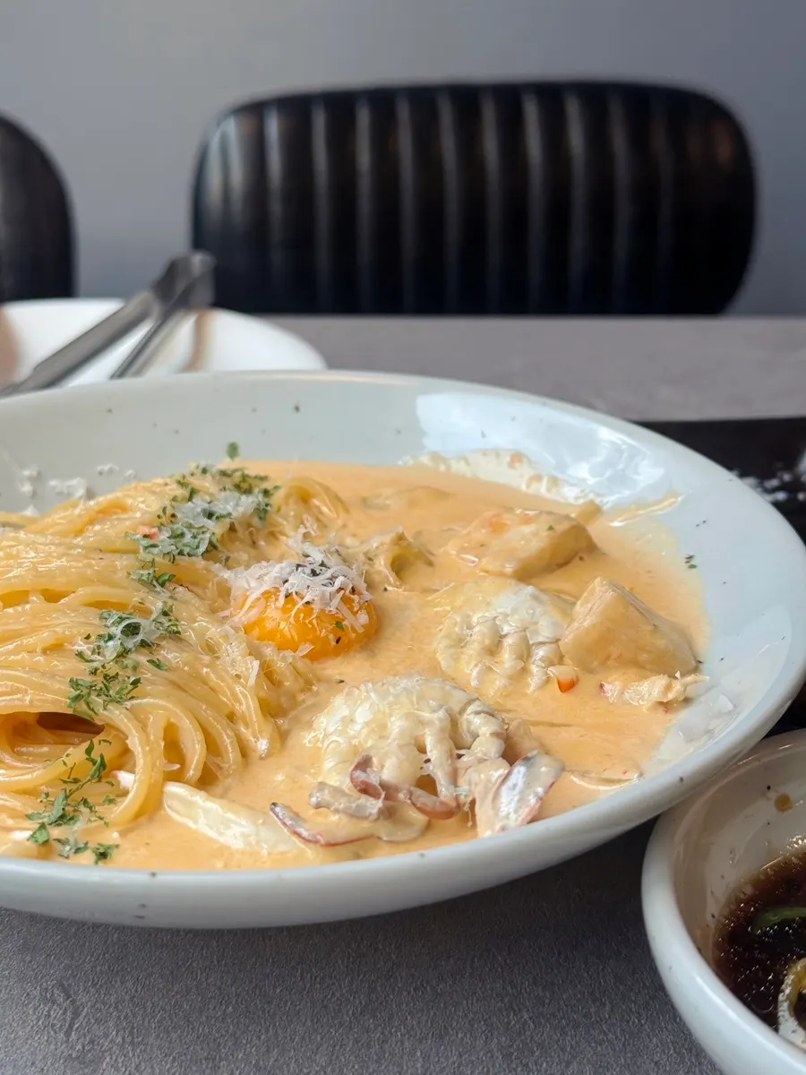 Crab cream pasta noodles lifted on a fork