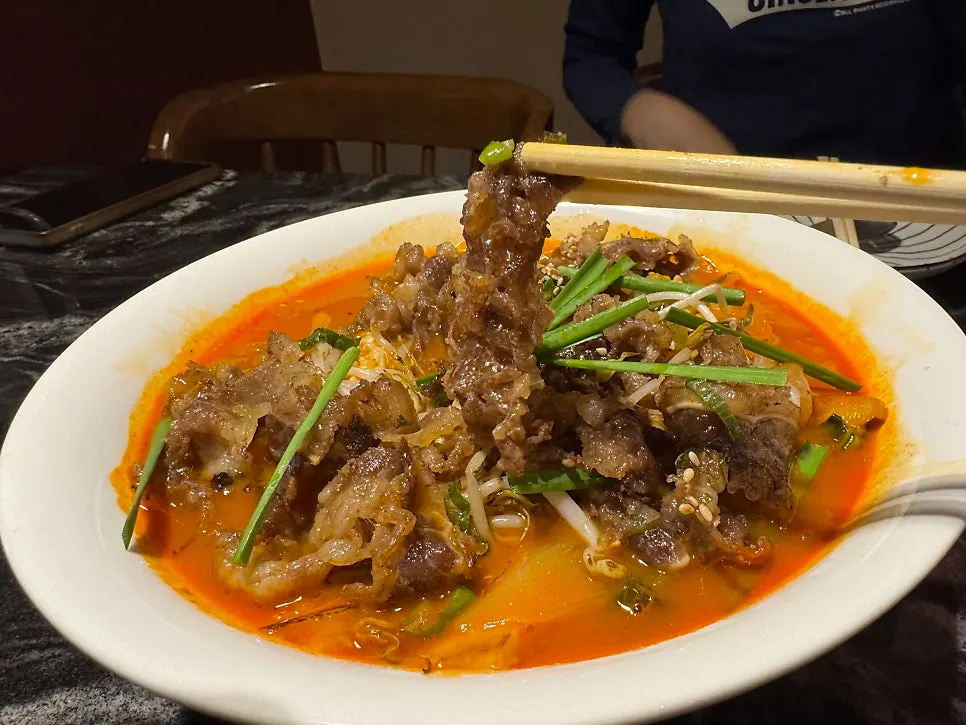 A piece of sweet and sour pork with a familiar sauce
