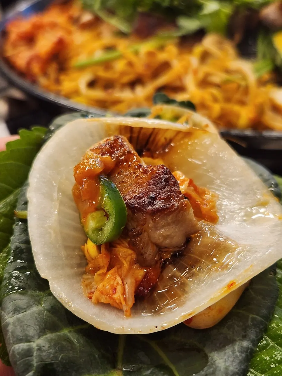 Grilled pork belly with minari and a piece of kimchi