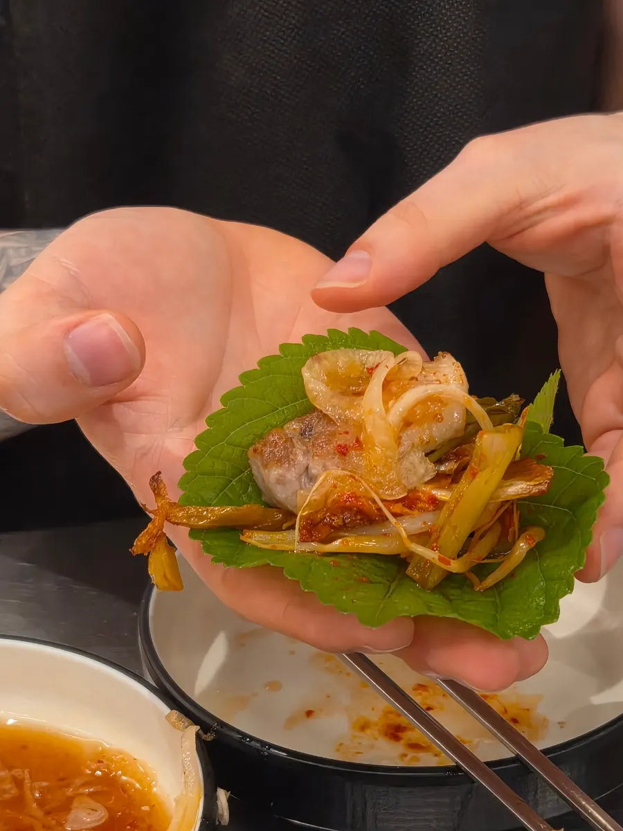 Perilla leaf wrap with pickled radish, bean sprouts, green onion kimchi and pork