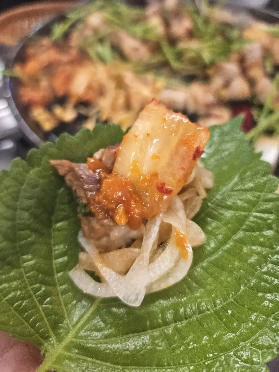 A pork-belly wrap made with ssam vegetables