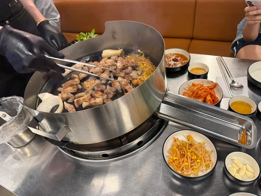 Staff grilling the meat and vegetables