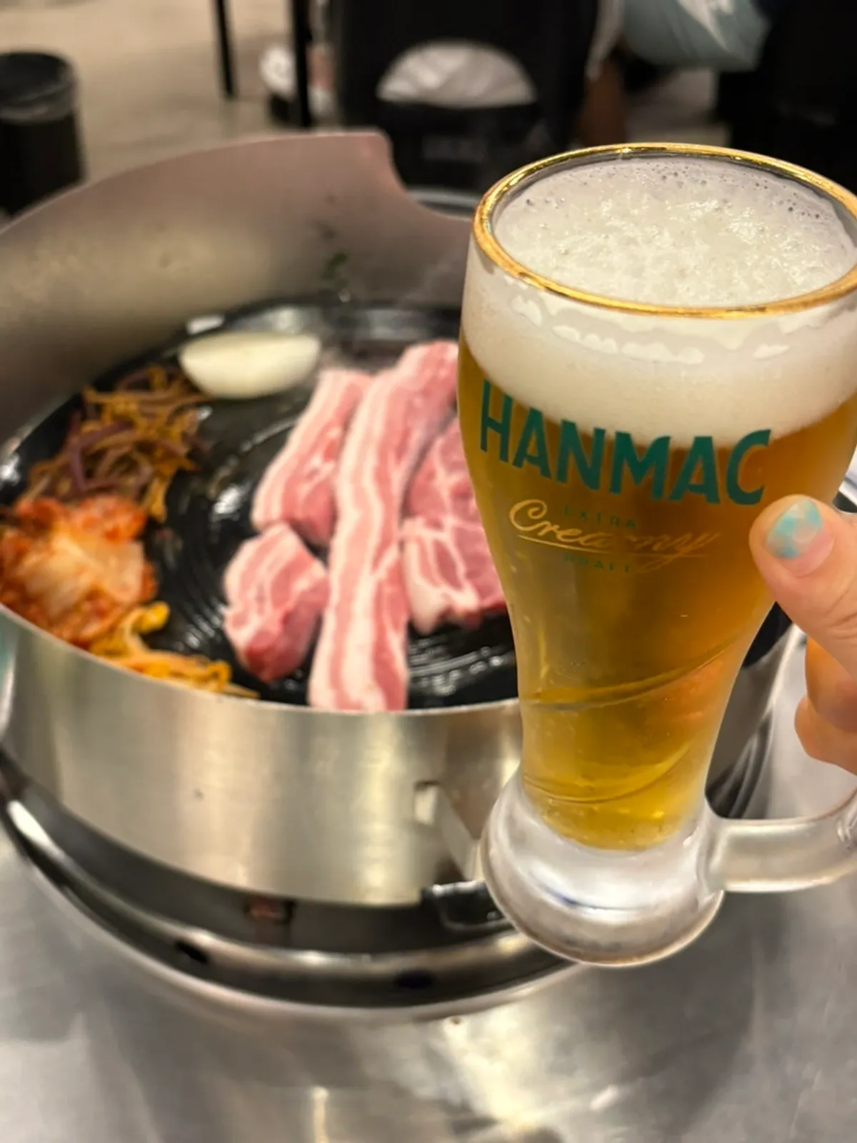 Staff grilling thick cuts of sotttukkeong samgyeopsal