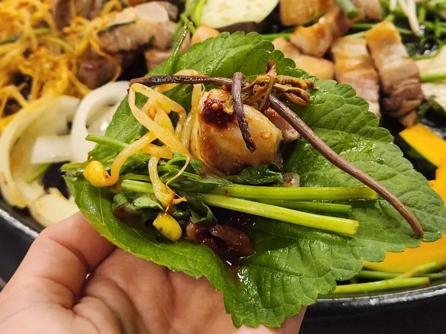 Perilla leaf wrap topped with minari and gosari
