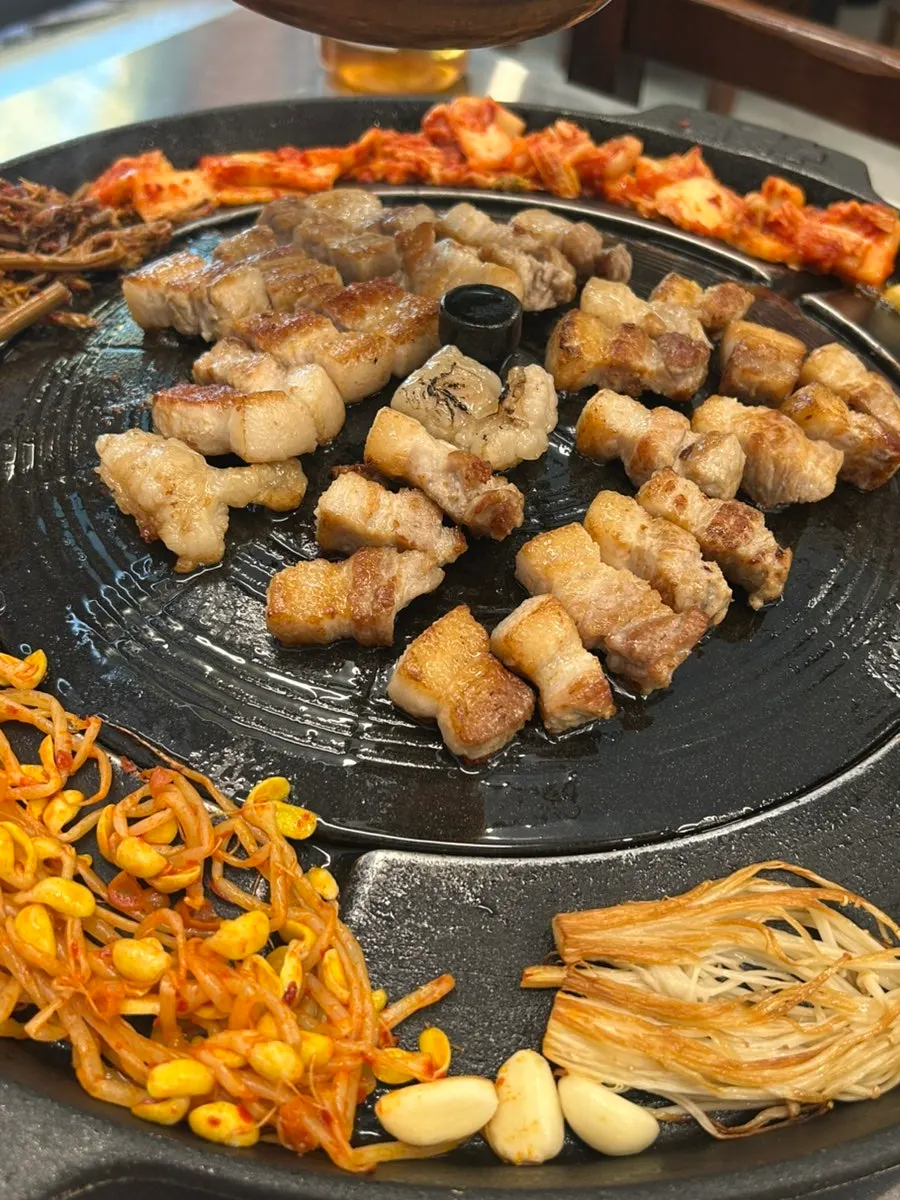 Staff grilling pork belly
