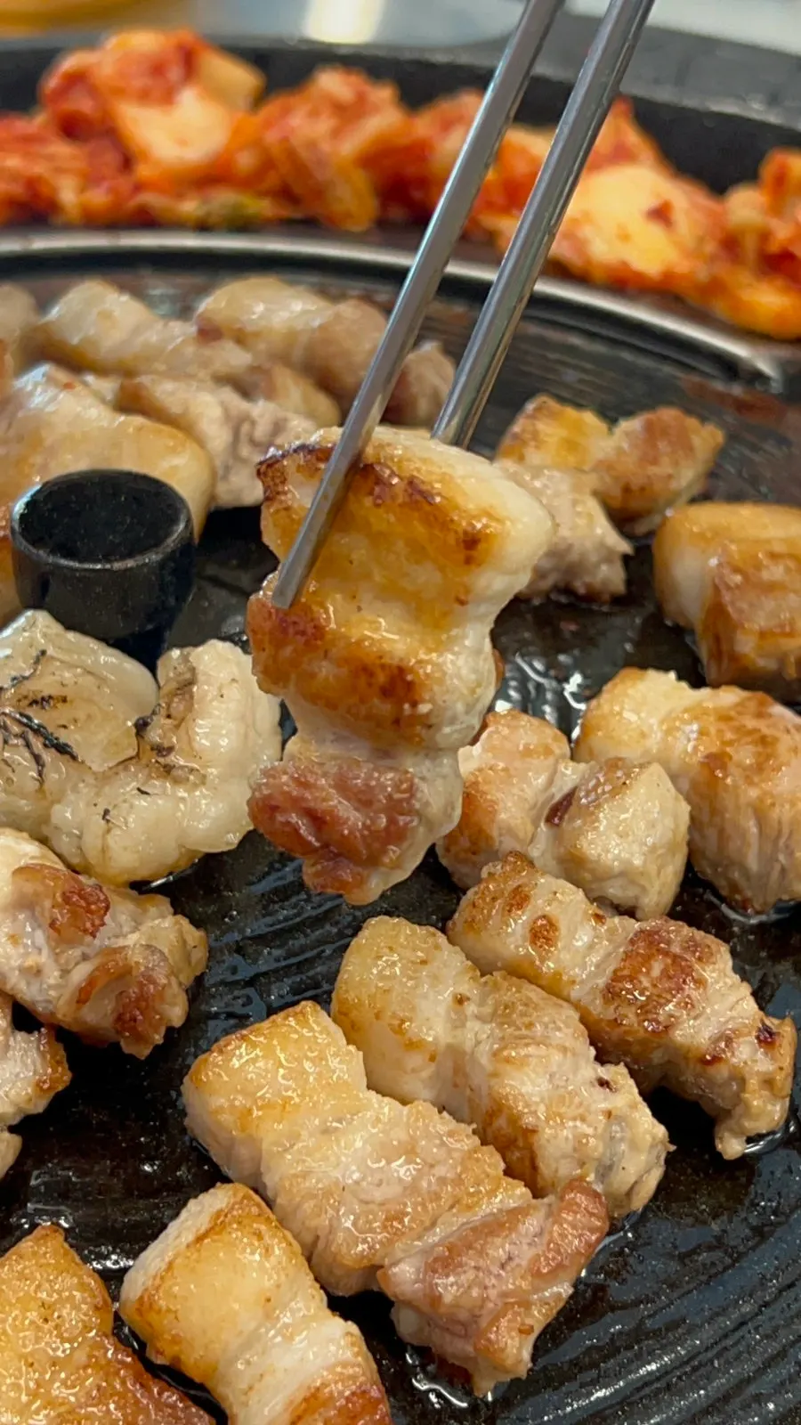 Pork belly and accompaniments on a pot lid
