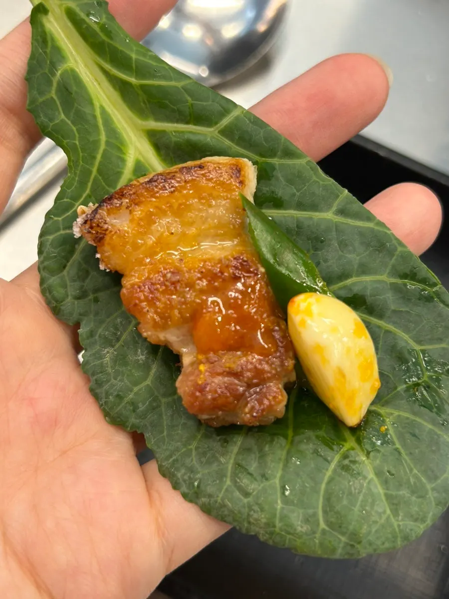Pork belly grilled on a pot lid