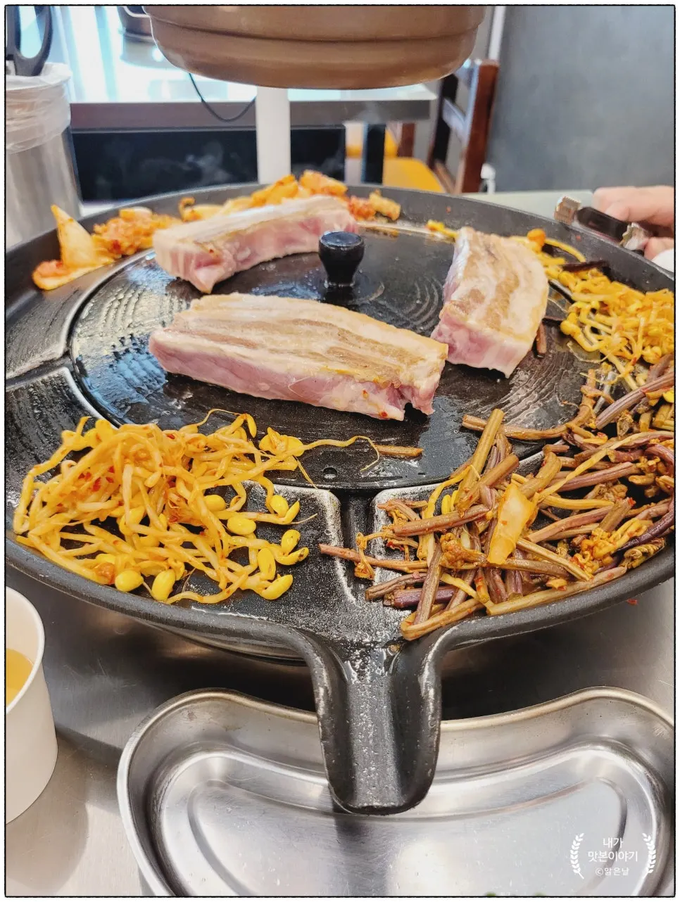 Two servings of thick raw pork belly placed on the iron lid