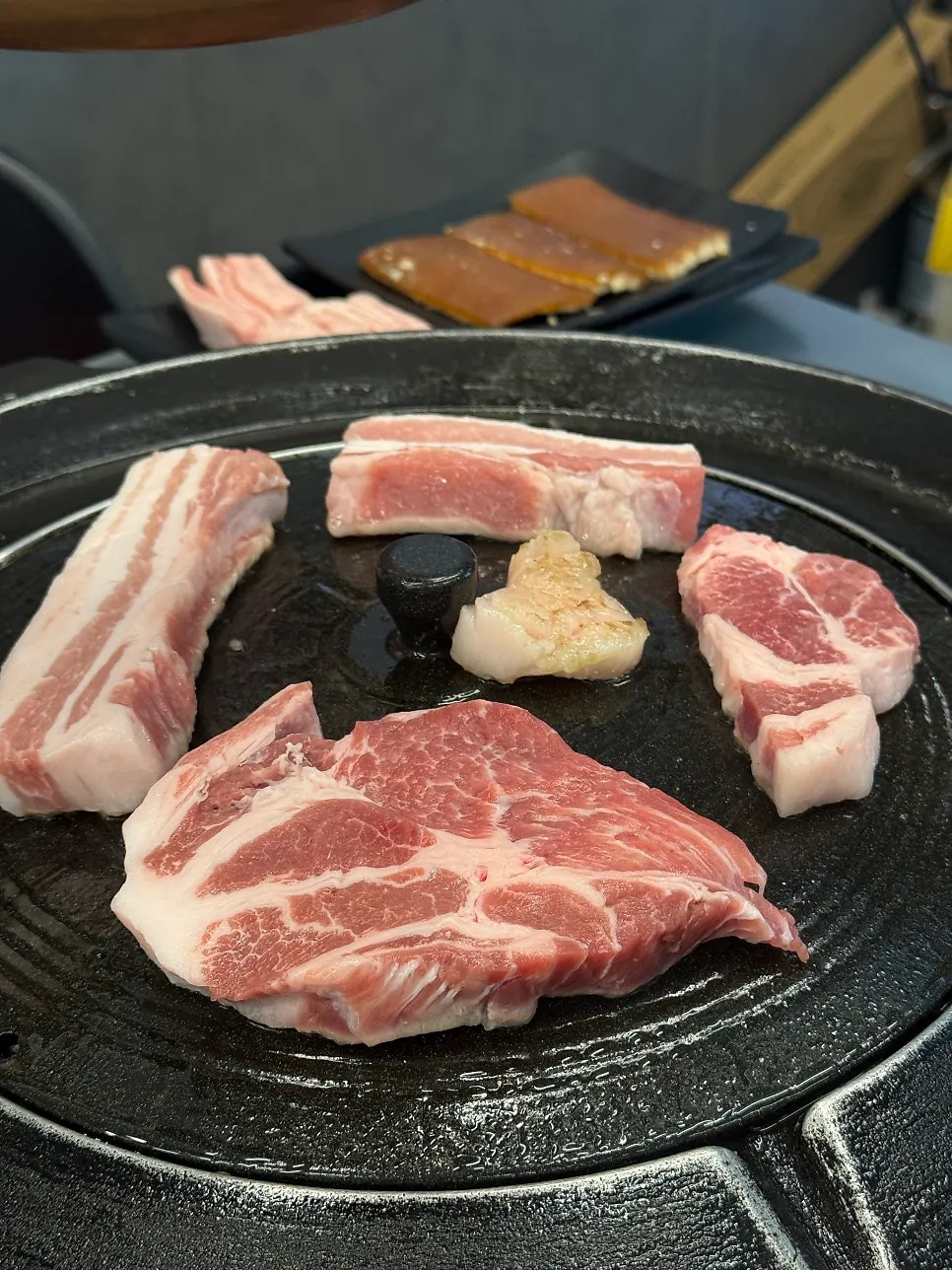 Pork belly and pork neck on the iron lid