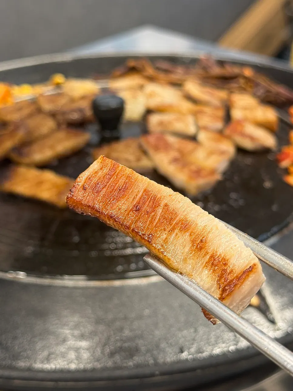 A fully grilled piece of pork jowl