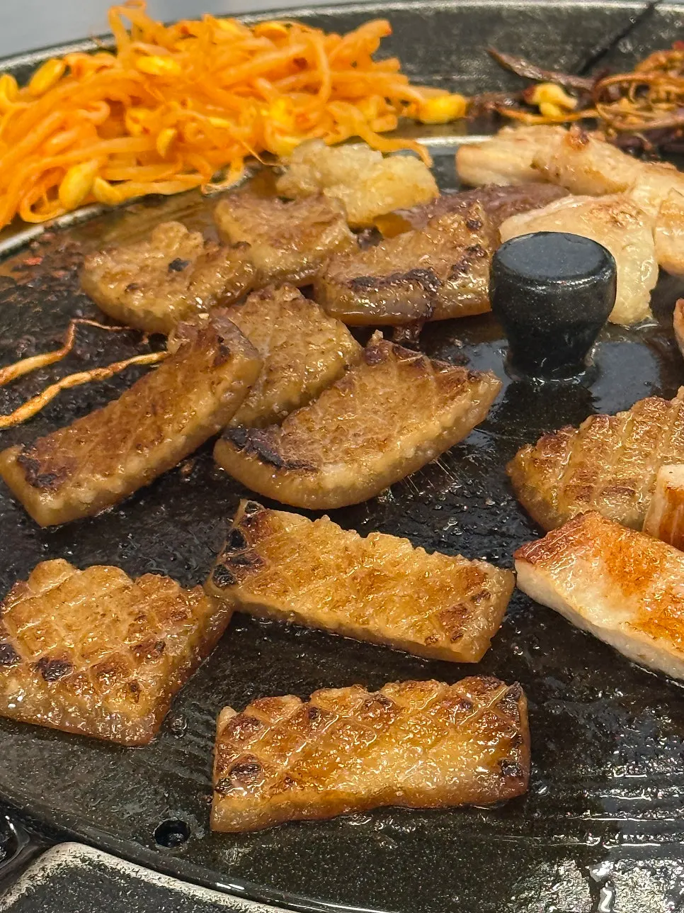 Pork skin grilling on the iron lid