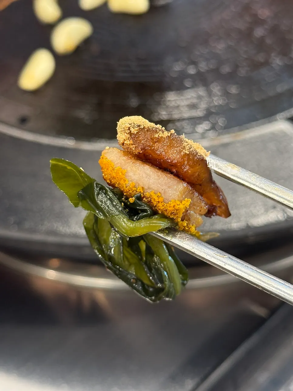 A wrap of wild garlic leaf with pork jowl and pork skin