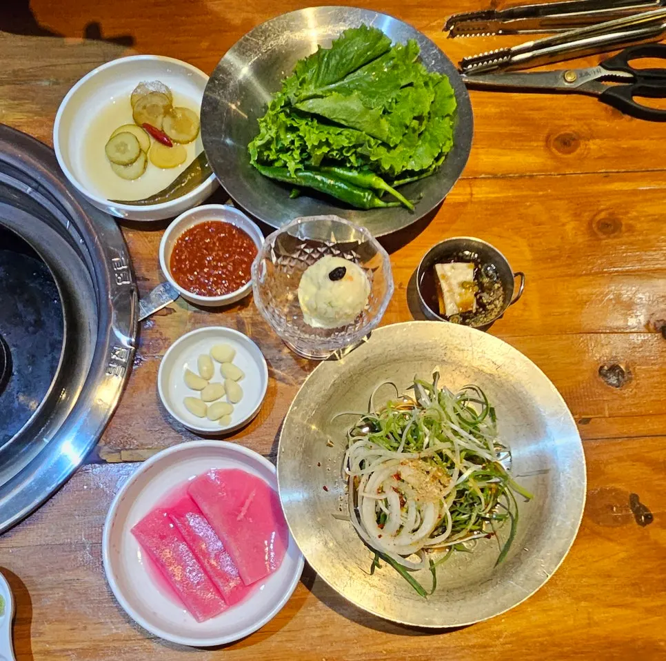 Table set with lettuce and scallion salad banchan
