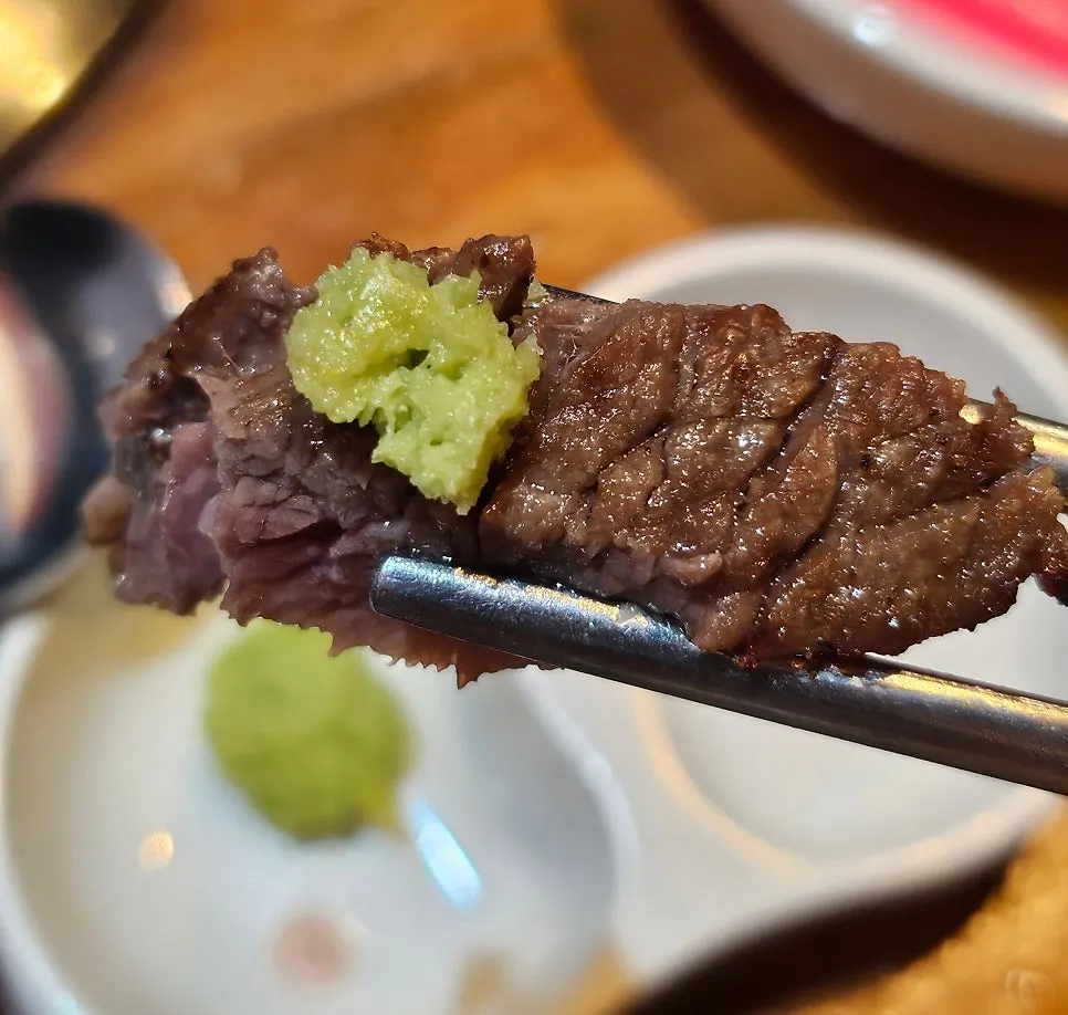 First bite of ugalbi with salt and wasabi
