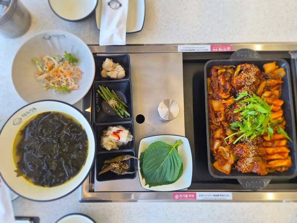 Braised ribs topped with seafood and minari