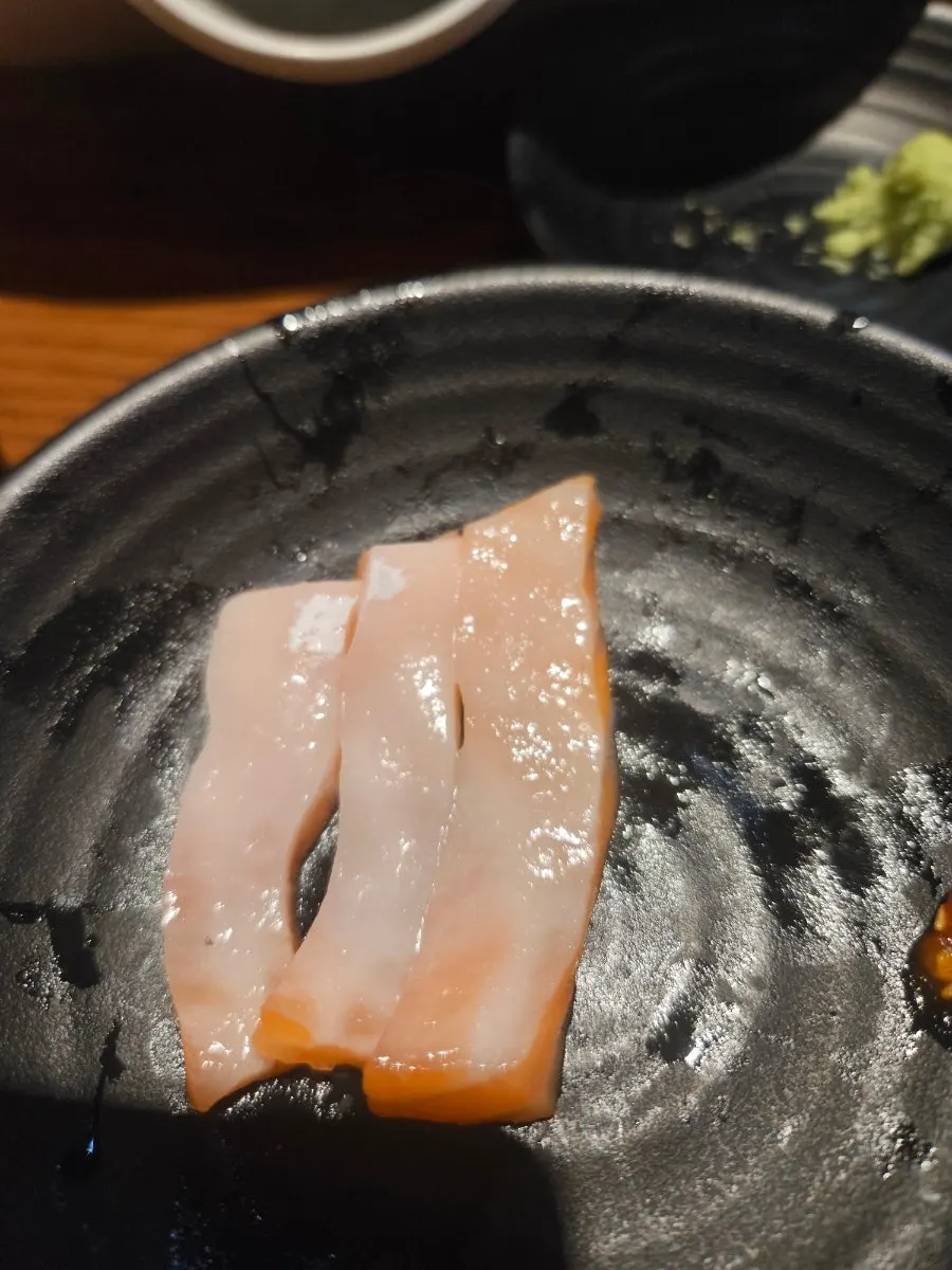 Yellowtail sashimi topped with pollack roe wrapped in seaweed