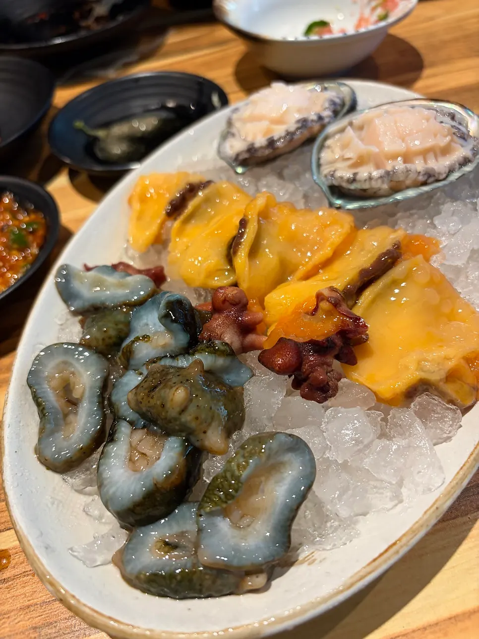 Full table spread with sashimi and side dishes