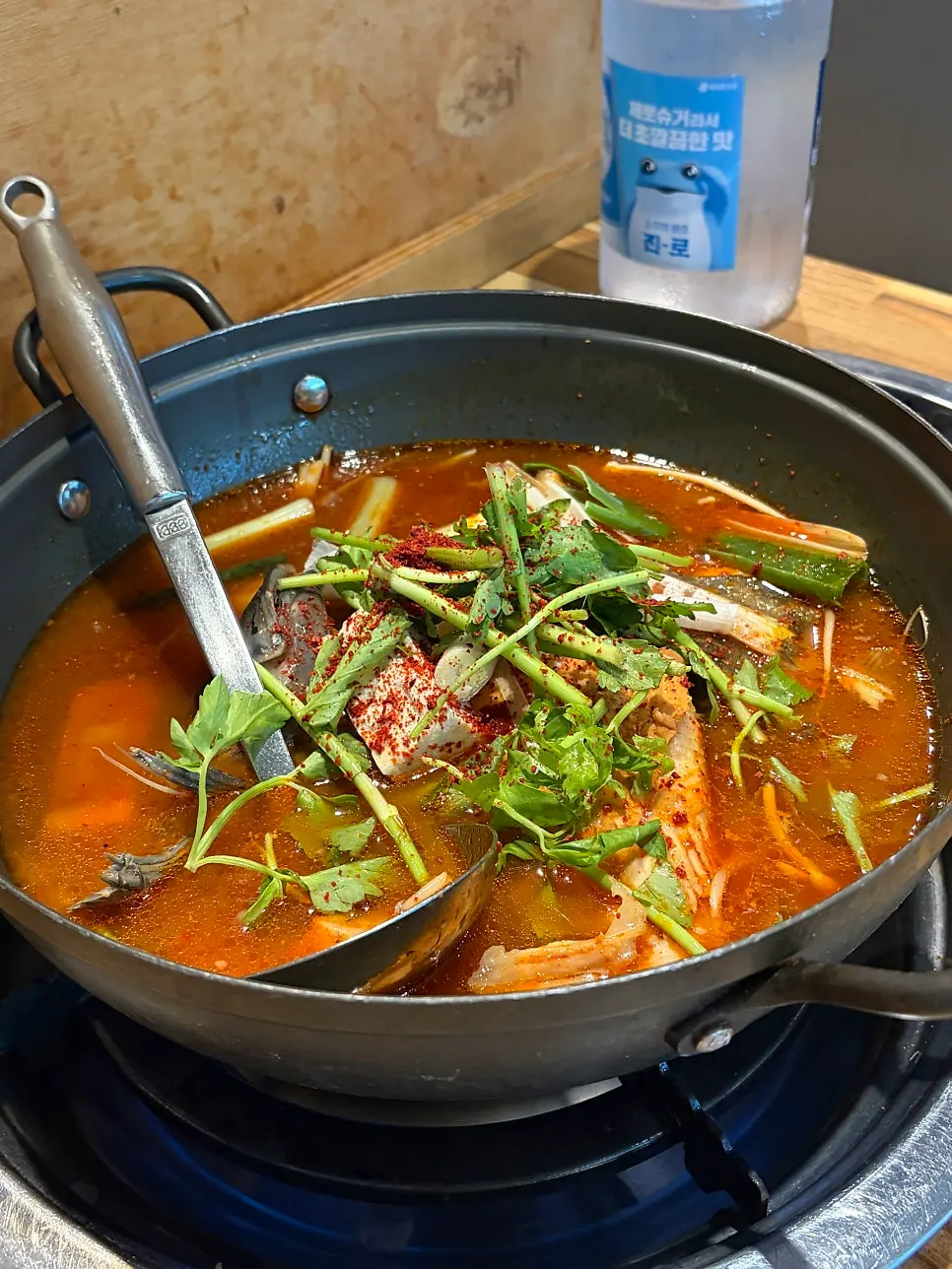 Pot of spicy fish stew simmering after the meal