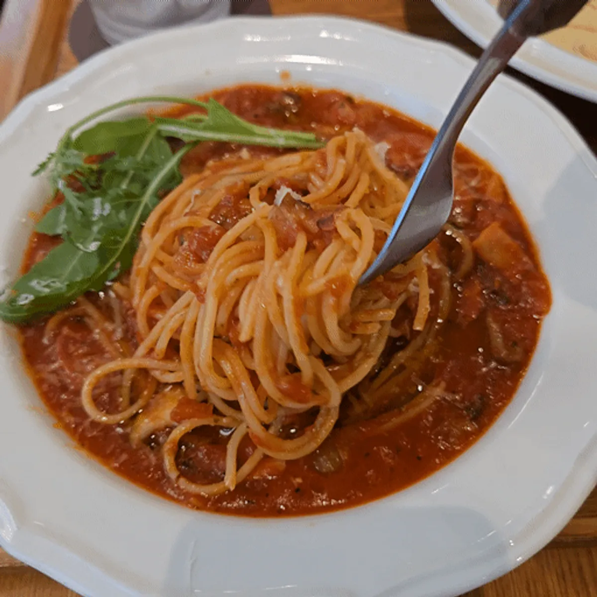 A plate of rucola arrabbiata pasta