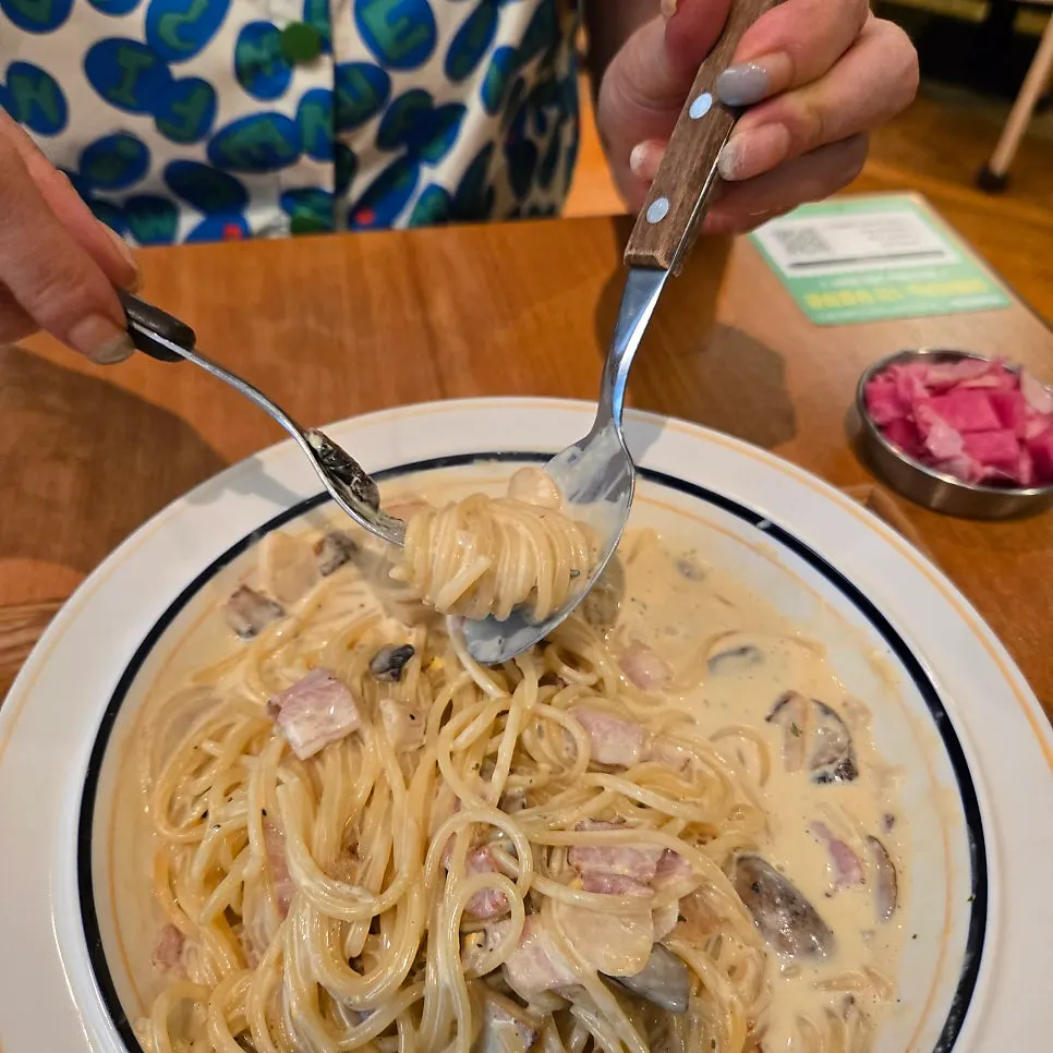 Carbonara cream pasta topped with cheese