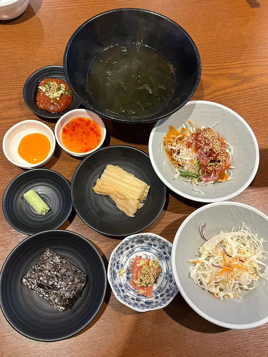 Table setting with seaweed soup, white kimchi and basic side dishes