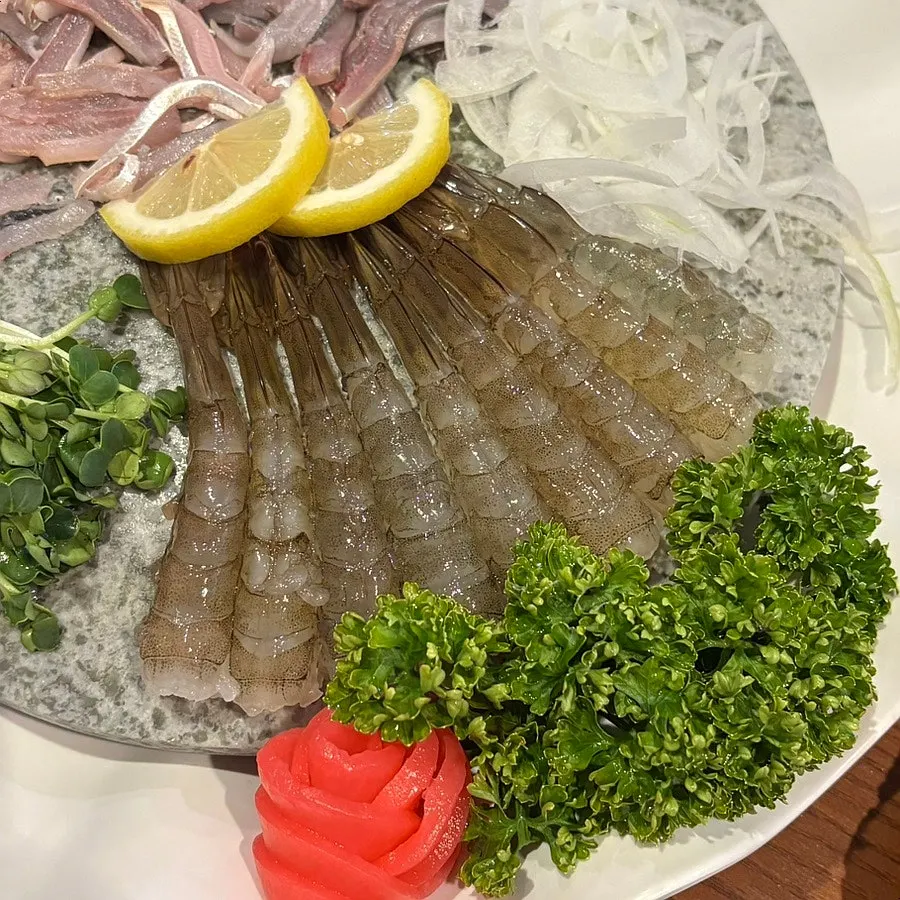 Close-up of peeled raw shrimp sashimi