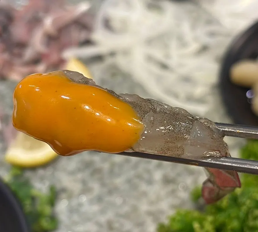 Raw shrimp sashimi dipped in buldak mayo sauce