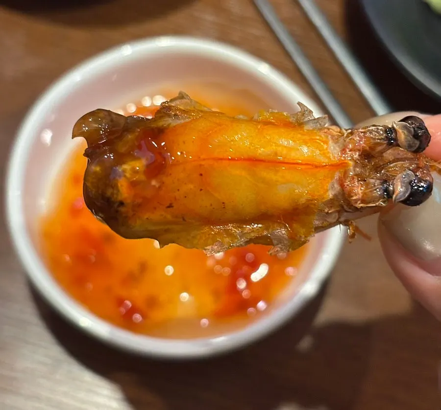 Fried shrimp head dipped in chili sauce