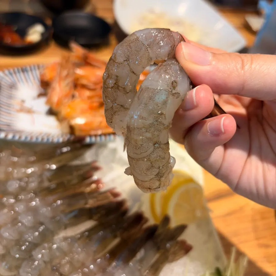Close-up of plump, glossy raw shrimp sashimi