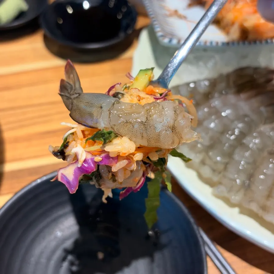 Raw shrimp sashimi placed on top of hoedeopbap