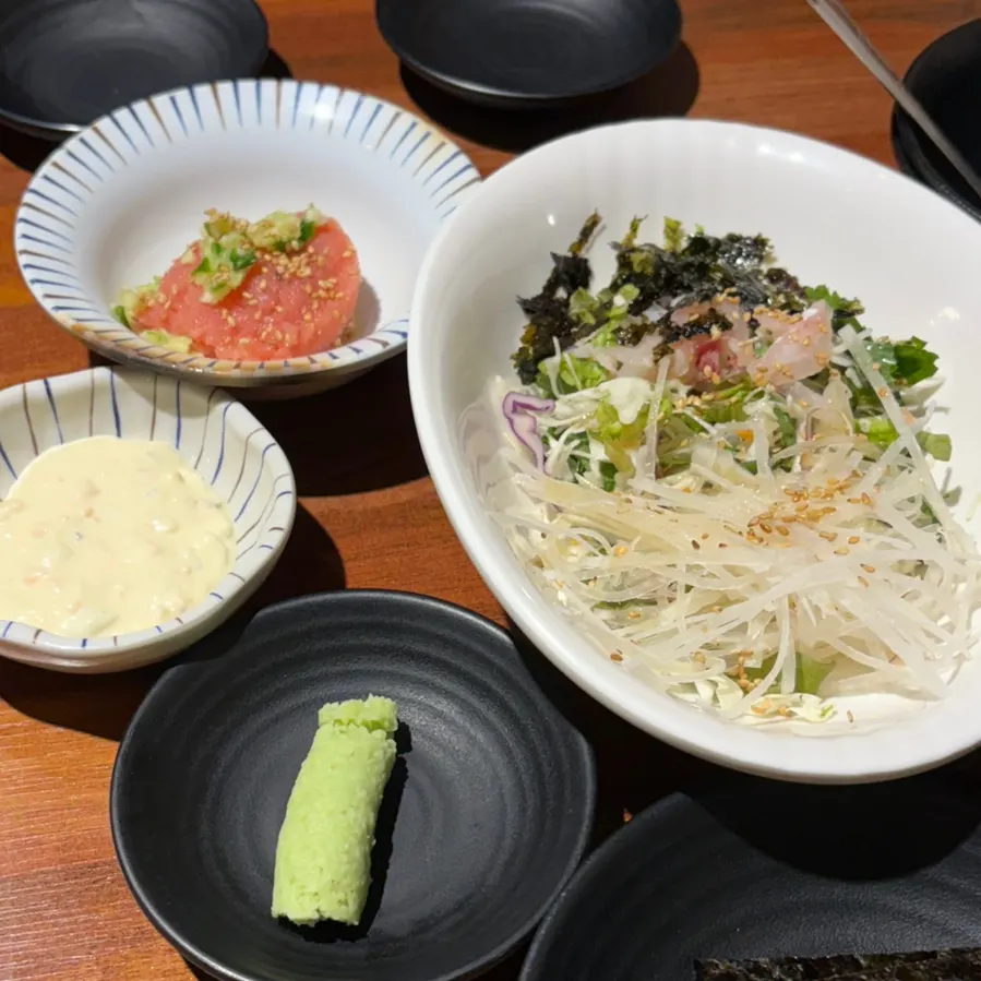 Side dishes of ssamjang, washed kimchi, and fresh wasabi