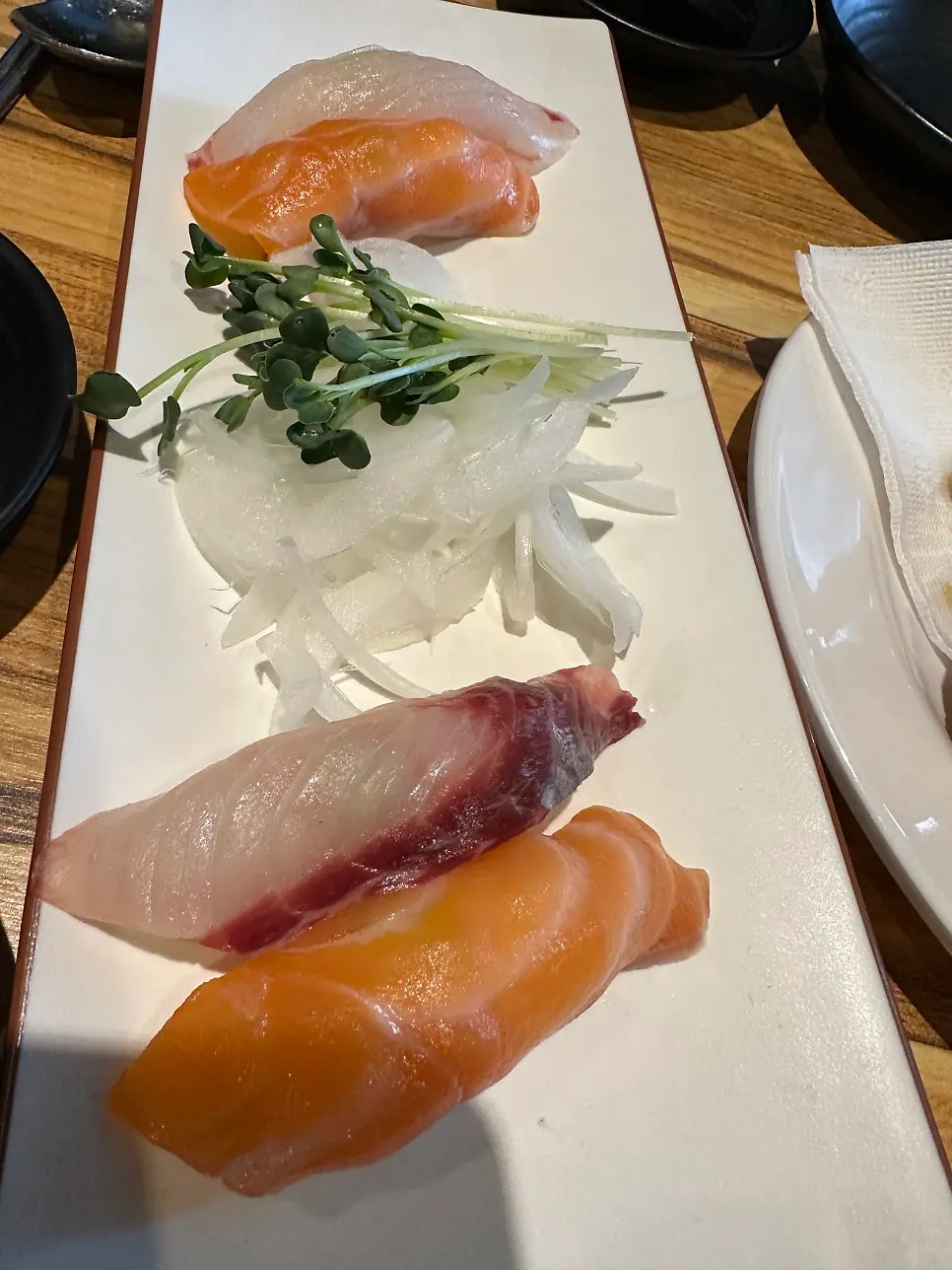 Plate of sushi topped with wasabi