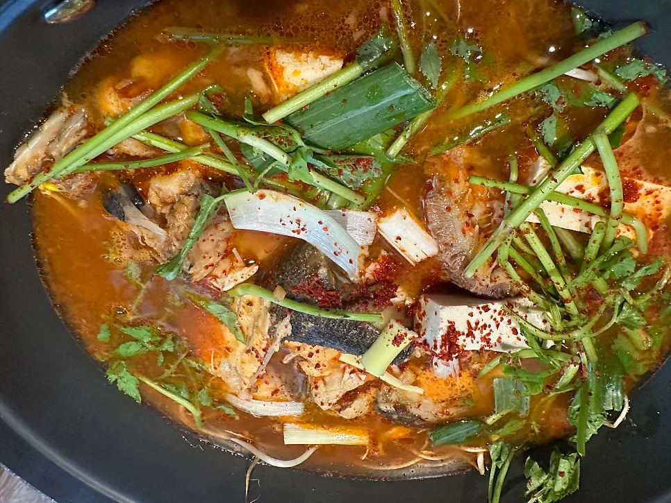 Pot of spicy stew with a fiery broth