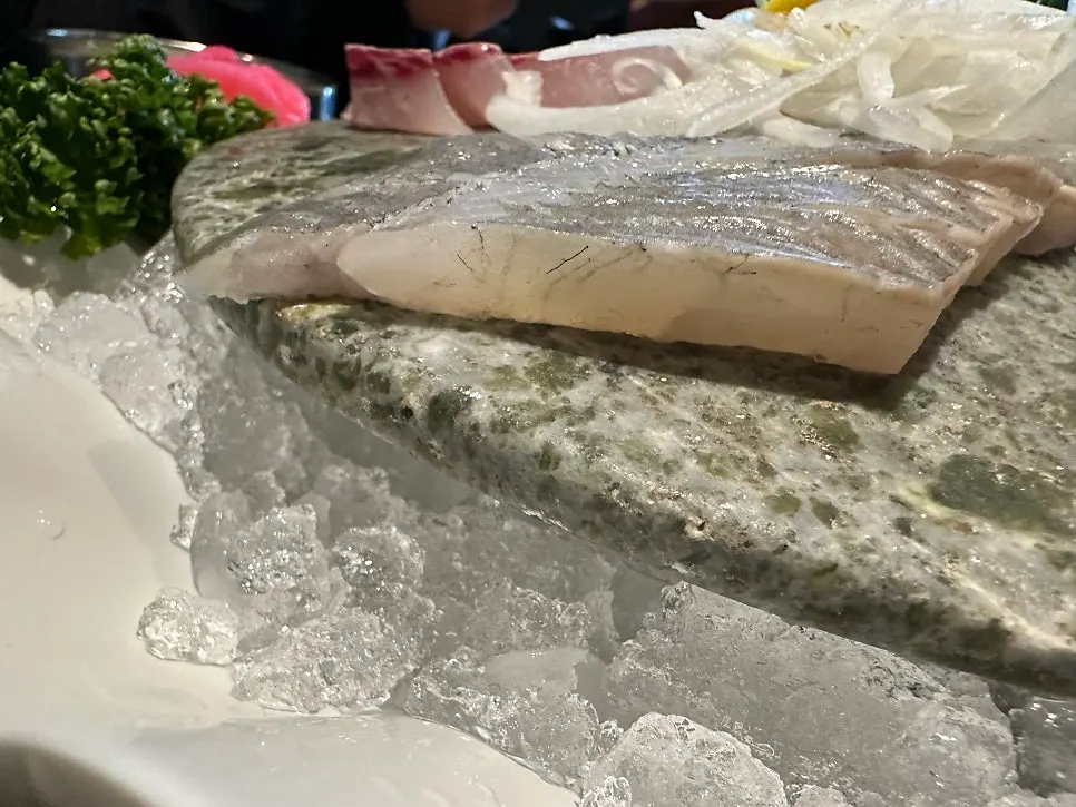 Close-up of thickly sliced live fish sashimi
