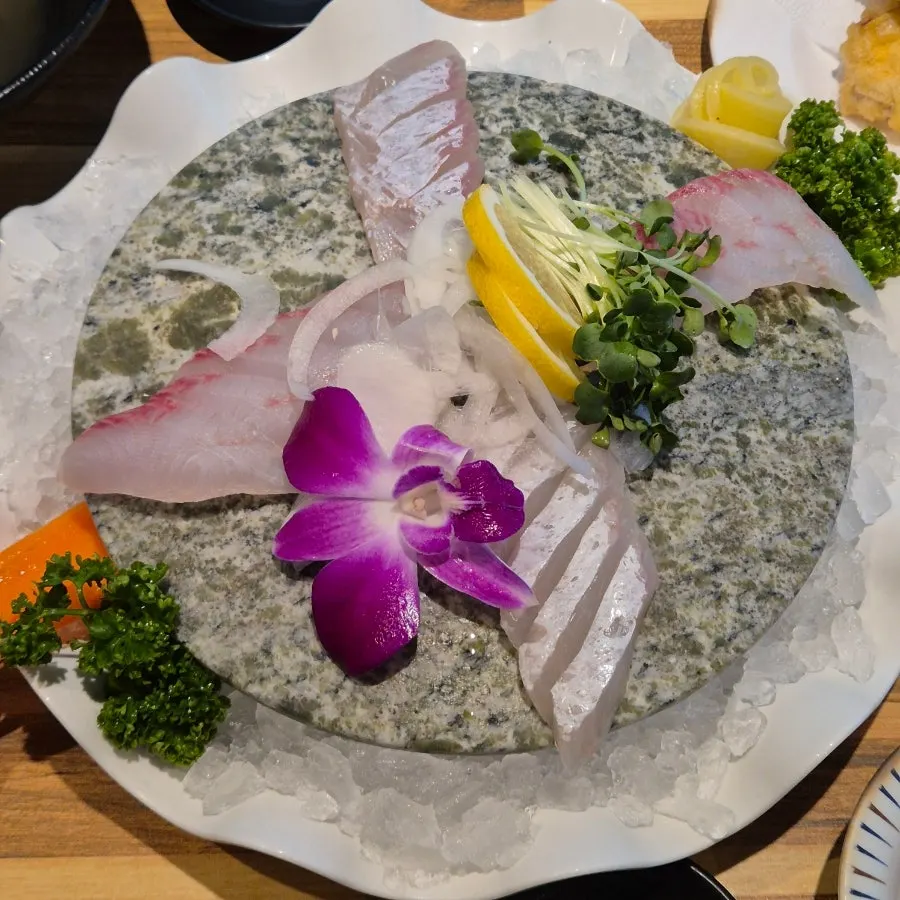 One piece each of raw fish sushi and salmon sushi
