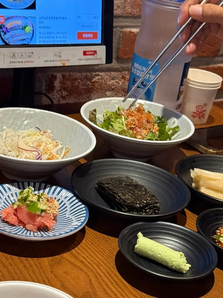 Basic table setting with cabbage salad and vinegar-gochujang sashimi salad